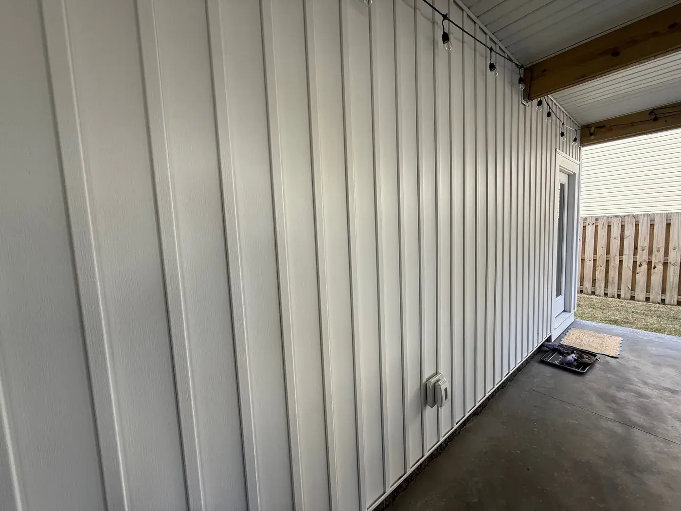 Clean white vertical siding after pressure washing