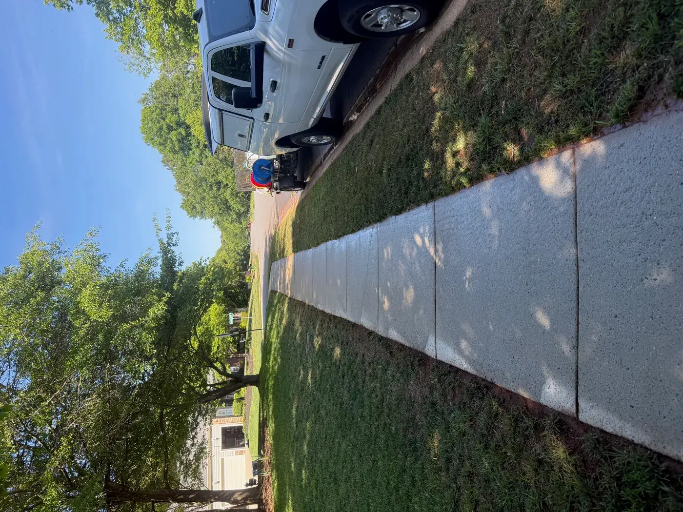 Clean sidewalk with Living Waters truck after cleaning